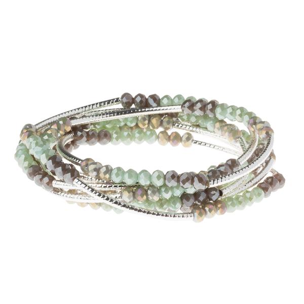 Introducing the "Wrap Iced Mint/Silver - You Are Some Kind of Wonder" by Scout Jewelry: a coiled bracelet adorned with strands of small crystal beads in green and brown hues, elegantly intertwined with silver-toned wires. The shiny finish on the beads creates a textured and layered appearance for this stunning piece.