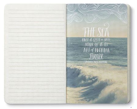 An open COMPENDIUM Find what brings you joy notebook displays lined pages on the left and a full-page illustration of a sea on the right. The bold sentiments of Jacques-Yves Cousteau's quote, "The sea, once it casts its spell, holds one in its net of wonder forever," are beautifully illustrated amid the waves.