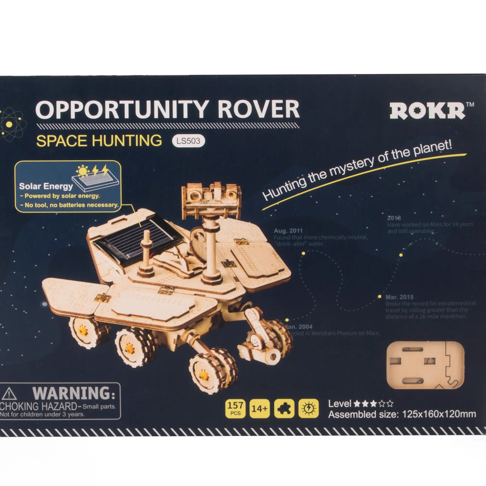 A box for the "DIY Solar Powered Rover" model kit by Robotime. This 3D puzzle showcases an illustration of the rover, emphasizing its solar-powered design, assembly size, and age recommendation. Set against a starry night sky, it includes a small parts warning and highlights its educational STEM benefits.