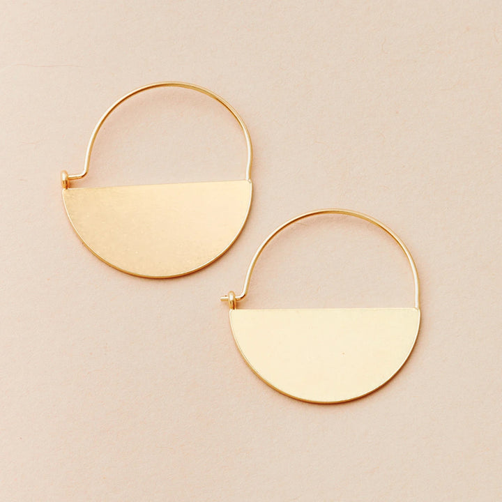 The Lunar Hoop Gold by Scout Jewelry showcases a pair of minimalist 18k gold vermeil hoop earrings with a semi-circular flat plate design set against a light beige background. Part of the Lightweight Refined Earring Collection, these elegant half-circle earrings offer timeless sophistication that attaches seamlessly to the hoop.