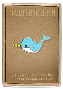 This adorable Narwhal Pin showcases a cartoon-style blue narwhal with a yellow tusk against a brown backdrop. Perfectly sized at just inches wide, it comes beautifully packaged in a charming gift box branded with "PeterPauperP, White Plains, New York.