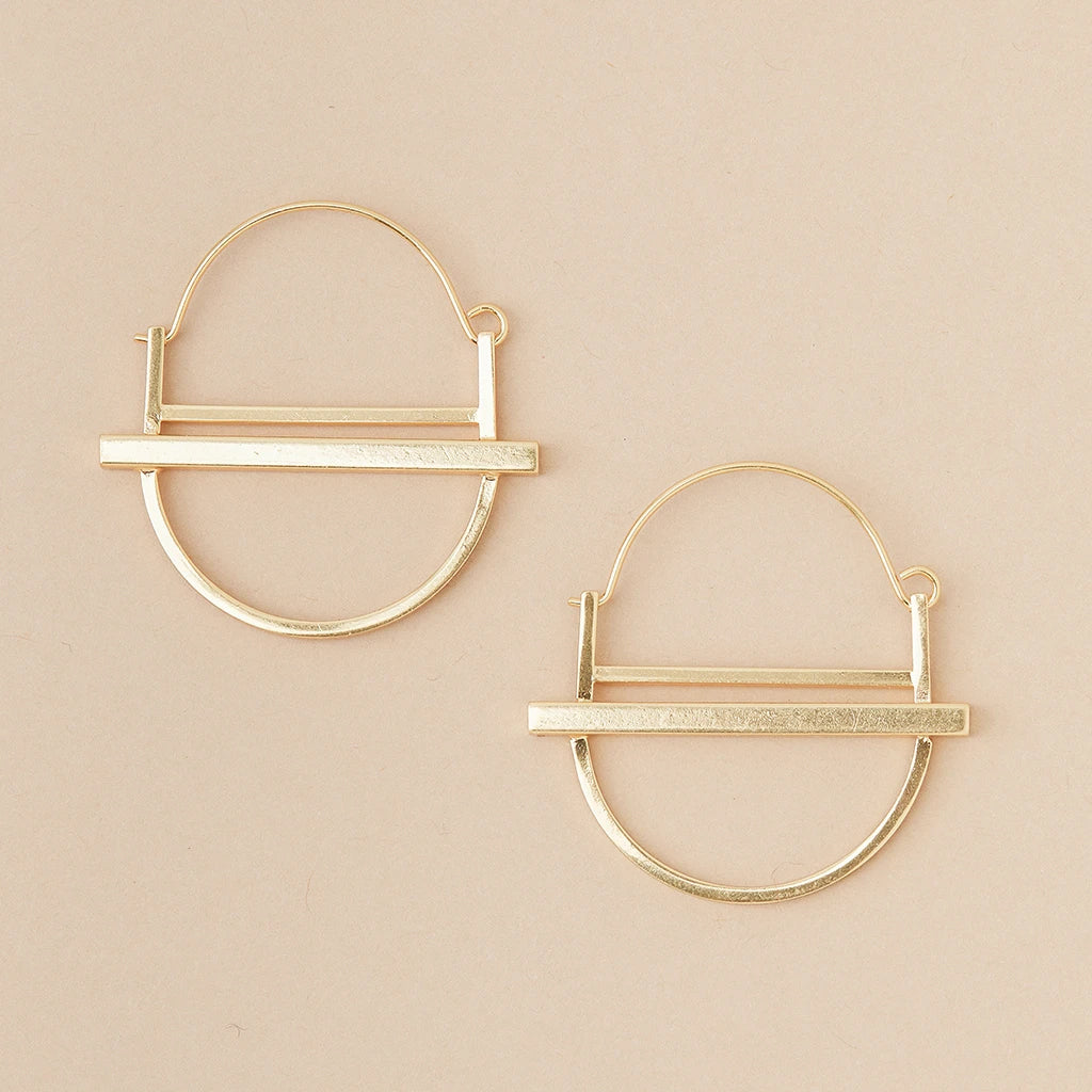 Scout Jewelry's Saturn Hoop Gold earrings are hypoallergenic, crafted from 18K gold vermeil with a half-circle base and horizontal bar, set on beige. These nickel and cadmium-free geometric designs blend style with comfort.