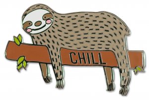 The Sloth Pin from PeterPauperP showcases a cheerful sloth relaxing on a branch adorned with vivid green leaves, alongside the word "CHILL." This charming design is ideal as a hard enamel pin, featuring a brown body with black dots, making it an adorable surprise in any gift box.