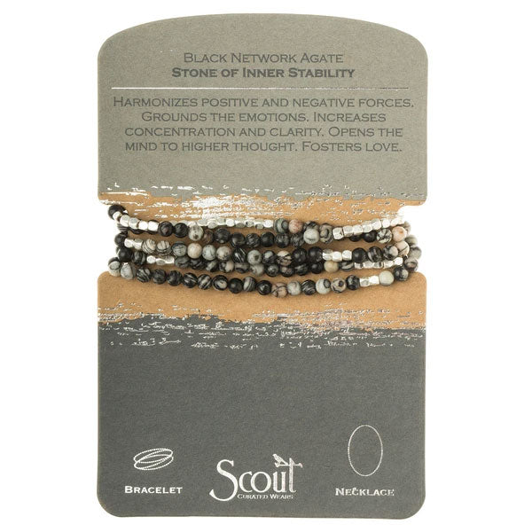 A Stone Wrap black agate/silver jewelry card by Scout Jewelry, featuring versatile 34" length bracelets and necklaces made of Black Network Agate. The card highlights the benefits of this semi-precious gemstone: balancing positive and negative energies, grounding emotions, enhancing concentration and mental clarity, and encouraging love and elevated thought.