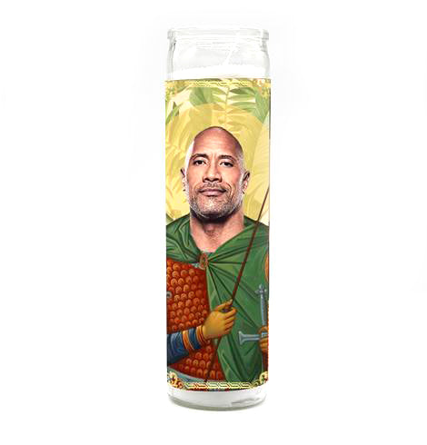 The Rock Candle by BOBBYK BOUTIQUE is an unscented devotional candle featuring a man in saint-like attire with green and orange robes, perfect for a celebrity shrine. Its tall, cylindrical shape and white background add elegance to any space.