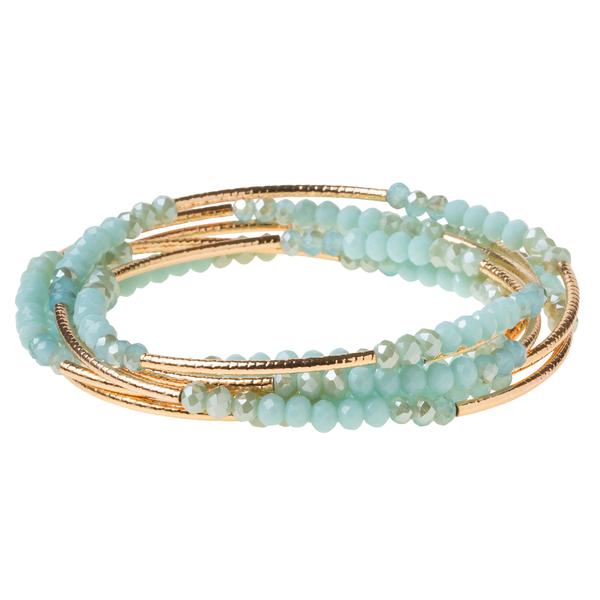 Introducing the "Always Be Yourself Mermaid" by Scout Jewelry, a beautiful piece featuring multiple thin gold bangles adorned with pale blue beads in a stunning turquoise combo.